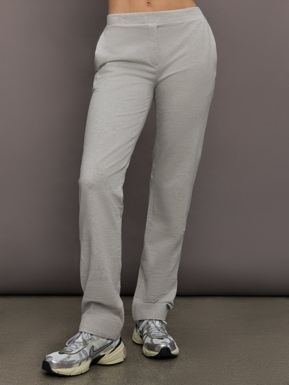 Model is wearing Flat Front Mens Pant in Light Heather Grey, front view.