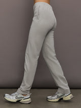 Model is wearing Flat Front Mens Pant in Light Heather Grey, side view.