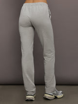Model is wearing Flat Front Mens Pant in Light Heather Grey, back view.