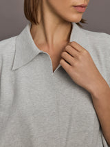 Model is wearing Super Oversized Sleeveless NK Bodysuit in Light Heather Grey, neckline close-up detail.