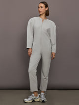 Model is wearing Bomber 1980s Zip Front Jumpsuit in Light Heather Grey, front view.