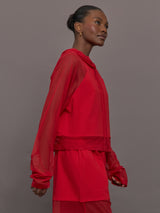 Model wears the Oversized Raglan Sleeve Hooded Cropped Top in Tiger Red, with mesh raglan sleeves and a mesh hood with a breathable design with a relaxed fit.