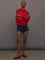 Model wears the Oversized Raglan Sleeve Hooded Cropped Top in Tiger Red, with mesh raglan sleeves and a mesh hood with a breathable design with a relaxed fit.