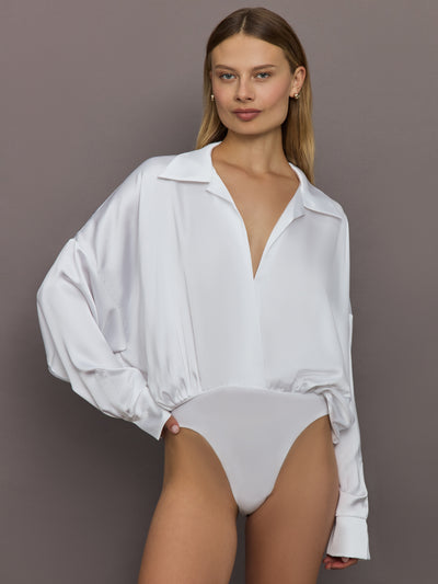 Front view of model wearing Super Oversized Boyfriend Shirt Bodysuit Snow White with deep neckline.