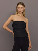 Front view of model wearing Strapless All Over Fringe Top Black with layered fringe detail.