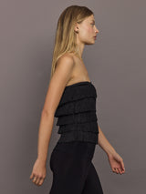 Side view of Strapless All Over Fringe Top Black showing tiered fringe design.