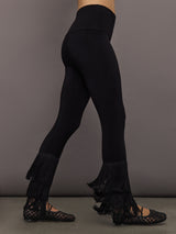 Side view of model wearing Fringe Hem Cropped Legging Black with layered fringe detail at hem.