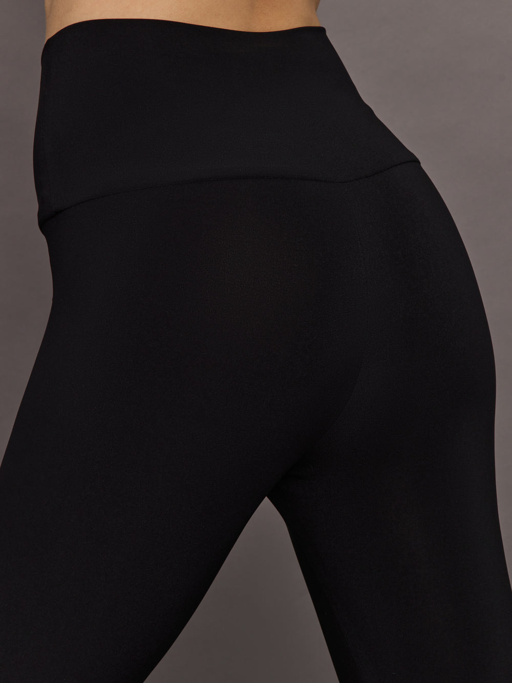 Close-up of Fringe Hem Cropped Legging Black waistband fit.
