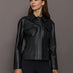 Woman wearing a black leather jacket against a gray background