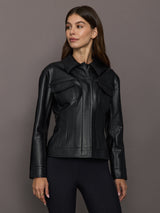 Woman wearing a black leather jacket against a gray background