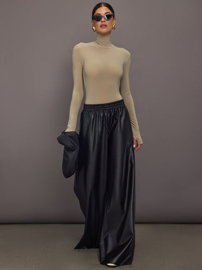 Model wearing a beige long-sleeve bodysuit.