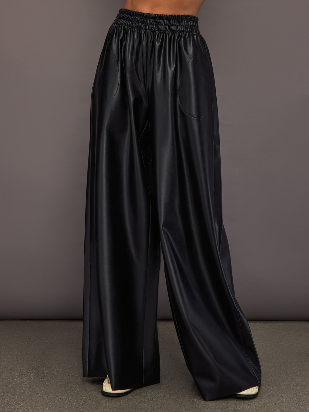 Model wearing Black satin wide-leg sweatpants pants