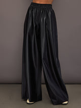 Model wearing Black satin wide-leg sweatpants pants