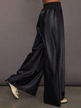 Model wearing Black satin wide-leg sweatpants pants