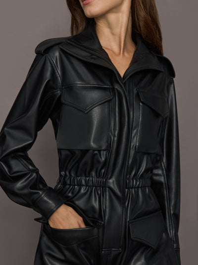 Black leather jacket worn by a person on a gray background