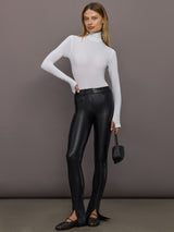 Model styled in Spat Jeans Black with white long sleeve top and black woven flats.