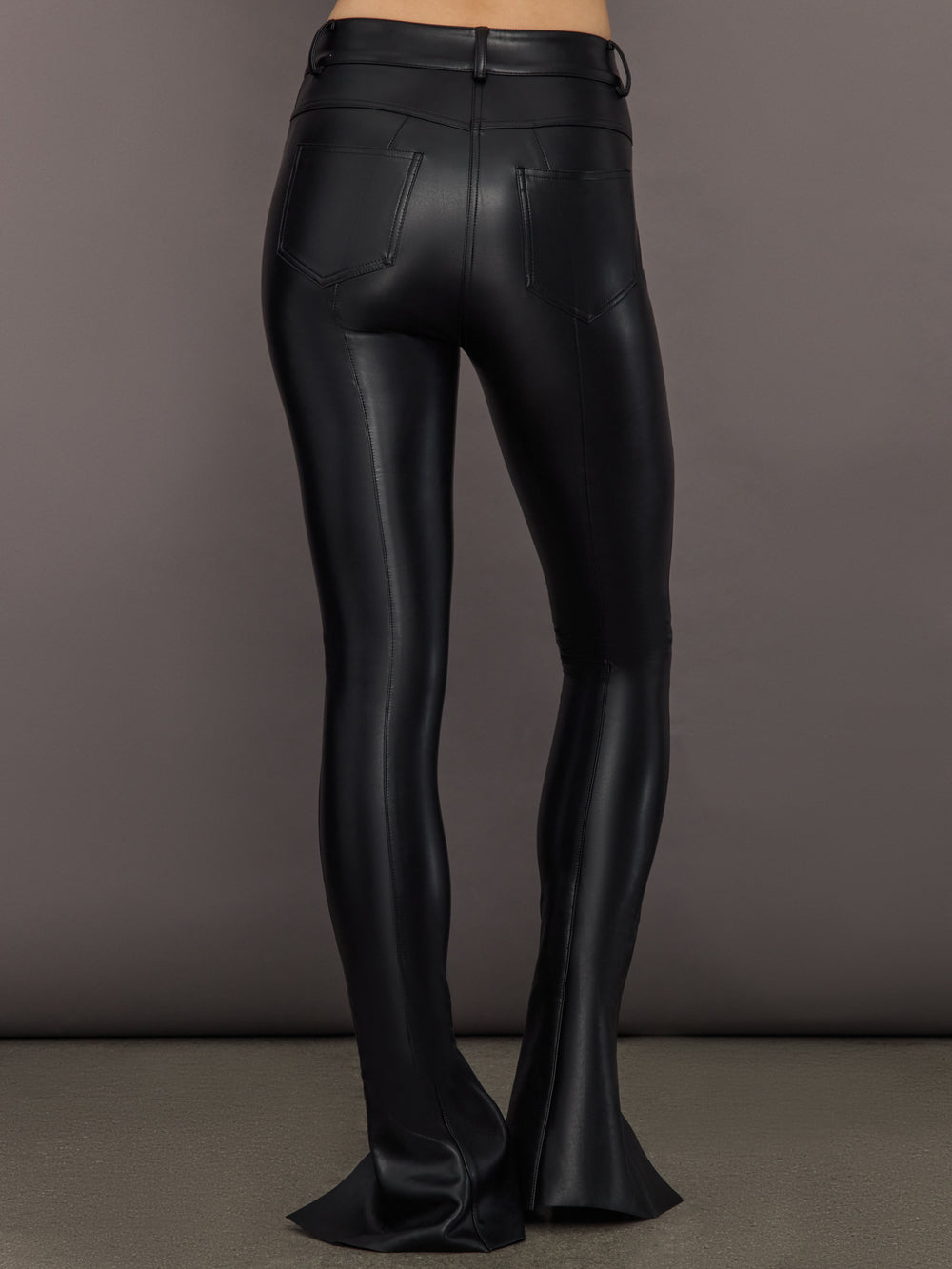 Back view of Spat Jeans Black with patch pockets and high-waisted fit.