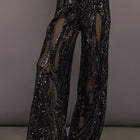 Front view of model wearing Boyfriend Elephant Sweatpant Black with sequin embroidered sheer overlay.