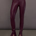 Model is wearing the Spat Jeans in Plum, full body front view.