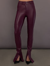 Model is wearing the Spat Jeans in Plum, full body front view.