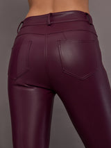 Model is wearing the Spat Jeans in Plum, close-up of vegan leather texture.