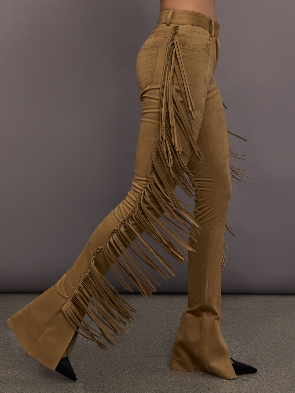 Model is wearing the Fringe Spat Jeans in Camel, side view highlighting fringe detail.