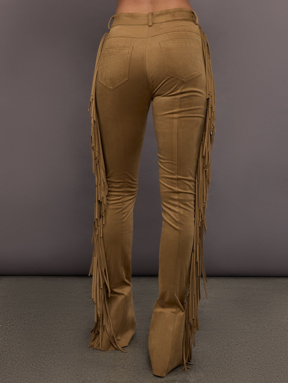 Model is wearing the Fringe Spat Jeans in Camel, back view with pocket detail.