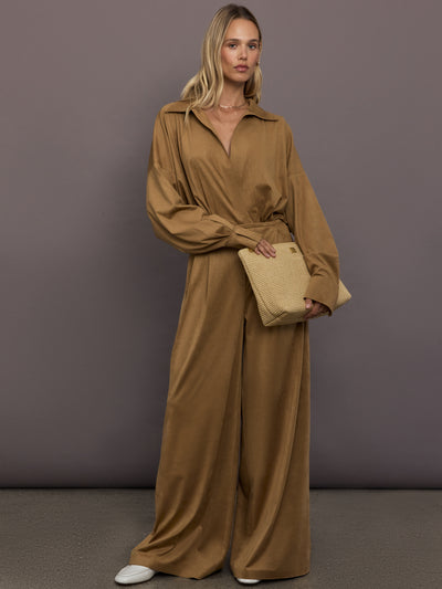 Model is wearing the Pleat Pant in Camel, side view showing wide-leg drape.