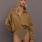 Model is wearing the Super Oversized Boyfriend Shirt Bodysuit in Camel, full body front view.
