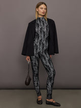 Model styled in Long Sleeve Slim Fit Turtle Catsuit with Footie Black White Lace layered with black blazer.