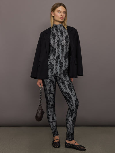 Model styled in Long Sleeve Slim Fit Turtle Catsuit with Footie Black White Lace layered with black blazer.