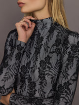 Close-up of Long Sleeve Slim Fit Turtle Catsuit with Footie Black White Lace mock neck detail.
