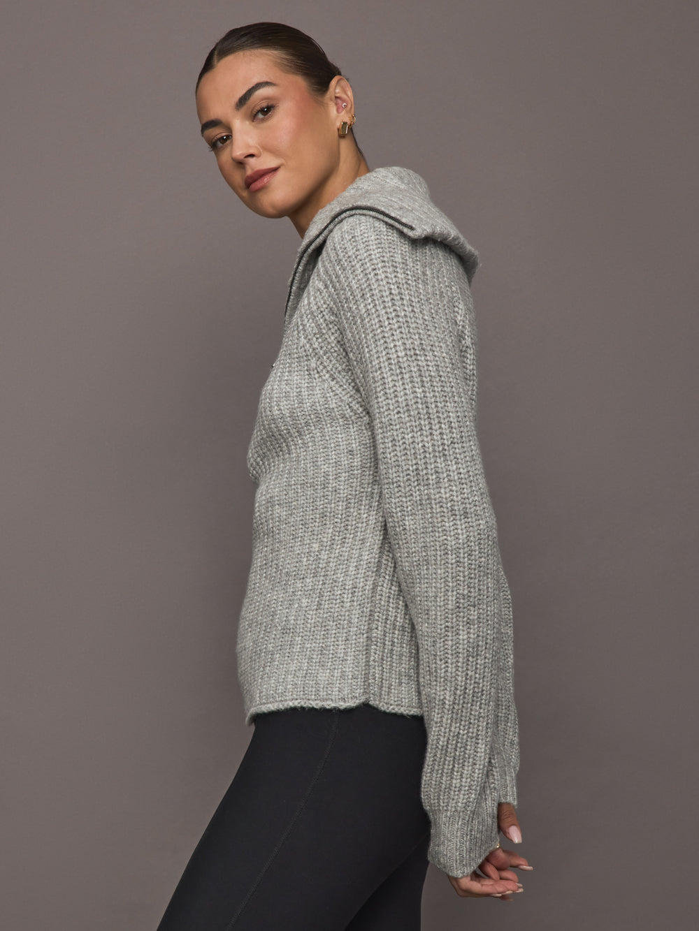 Side view of Half-Zip Ribbed Knit Sweater showing ribbed knit texture and high collar zipped up.