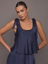 Model wearing Satin Tie Shoulder Tank Top in navy, front view.