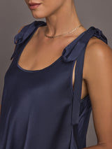 Model wearing Satin Tie Shoulder Tank Top in navy, close up.