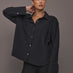 Model wearing Oversized Stretch Button-Down Shirt in black, front view.