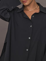 Model wearing Oversized Stretch Button-Down Shirt in black, close up  view.