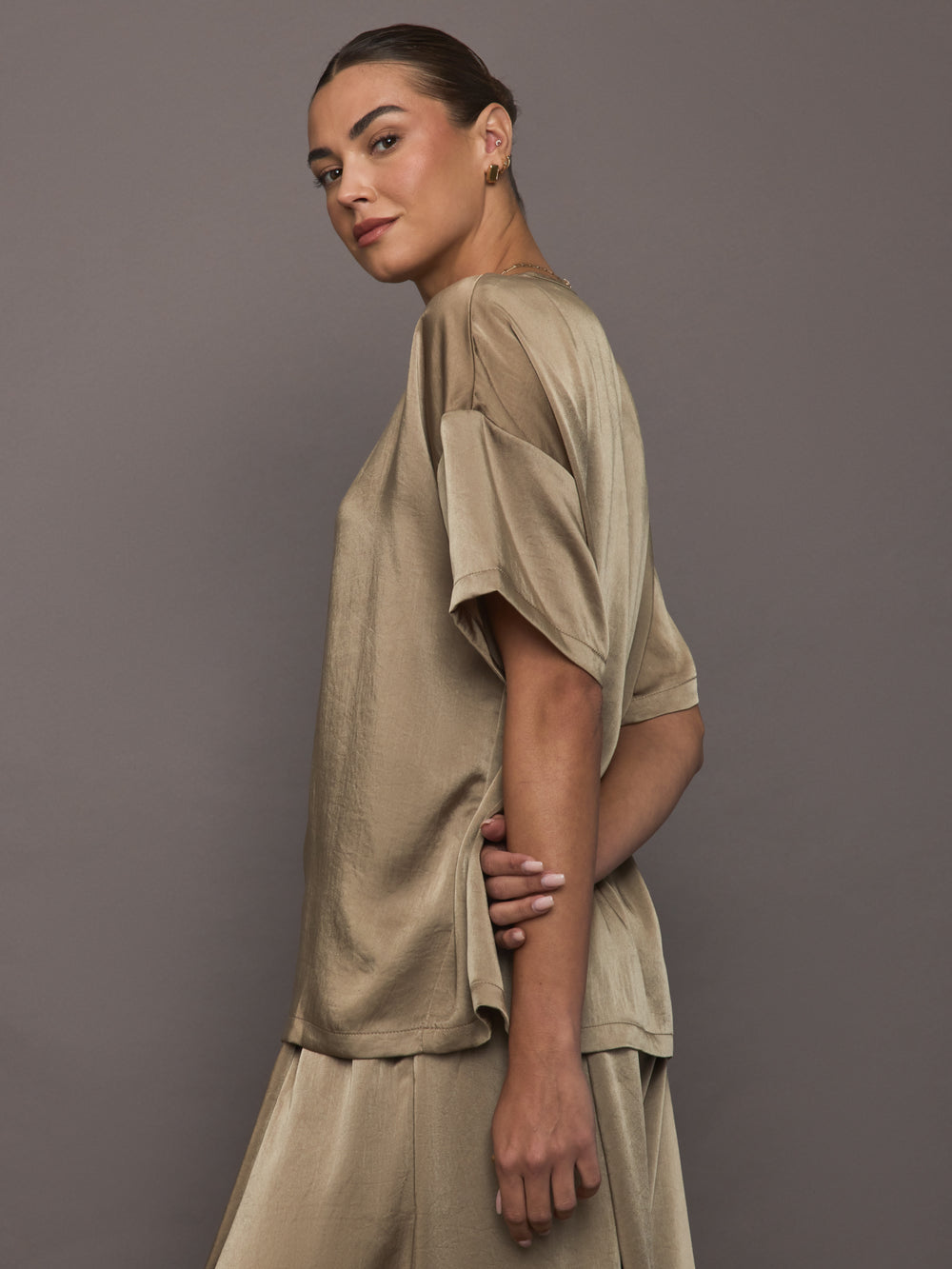 Side view of Elmwood oversized satin tee styled with matching shorts.