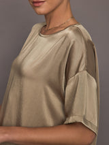 Close-up front view of model wearing oversized satin tee in Elmwood with drop shoulders.