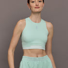 Model is wearing Train 2-in-1 Crop in Creek, front view.