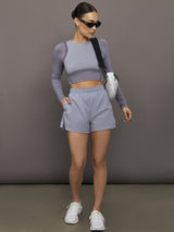 Model wears lilac-colored athletic shorts with a 3-inch inseam and an elastic waistband.