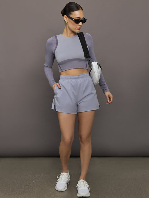 Model wears lilac-colored athletic shorts with a 3-inch inseam and an elastic waistband.