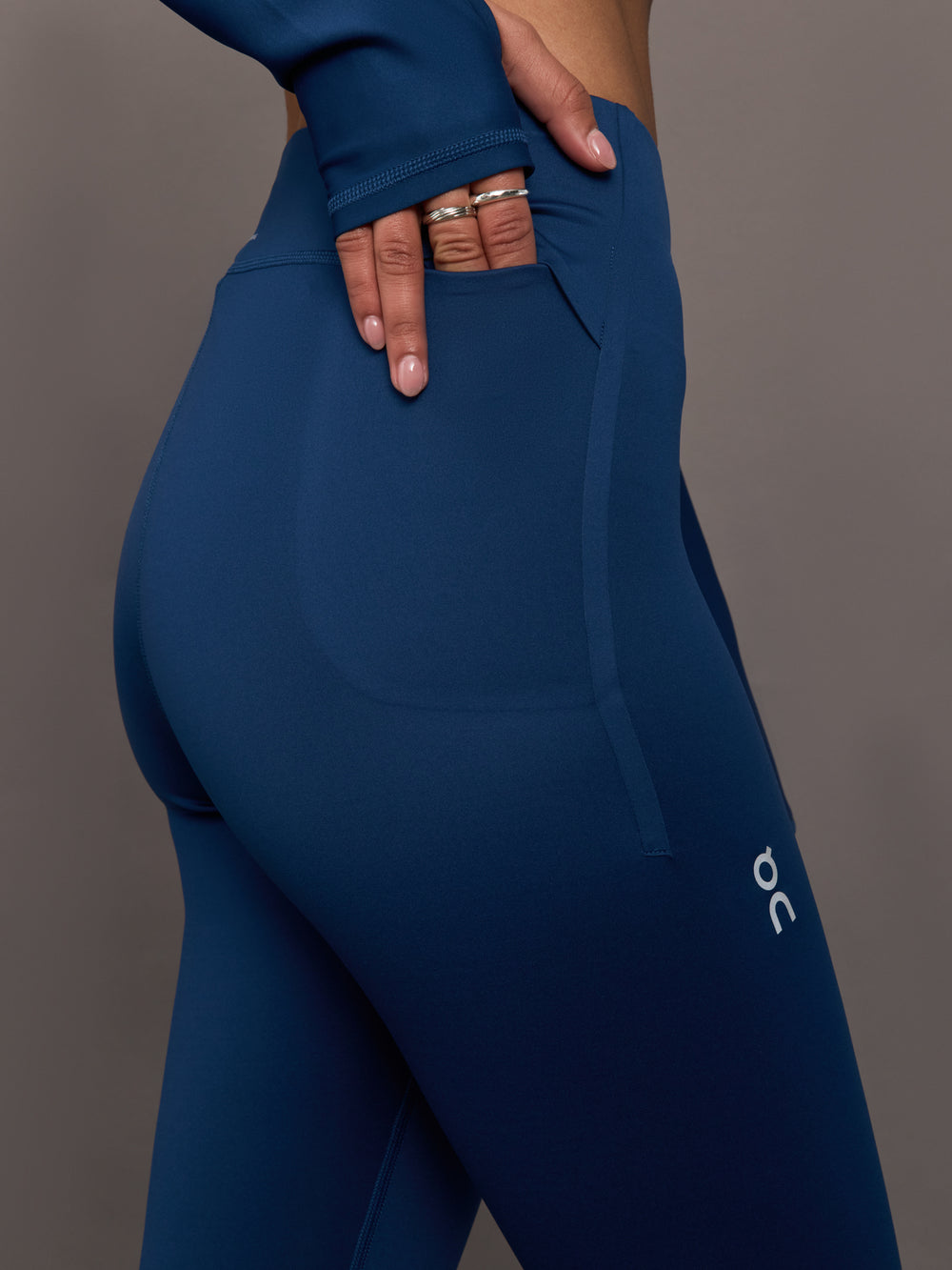 Blue leggings with a brand logo on a gray background