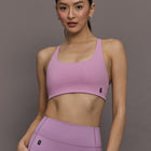 Model is wearing Studio Bra in Sakura, front close up.