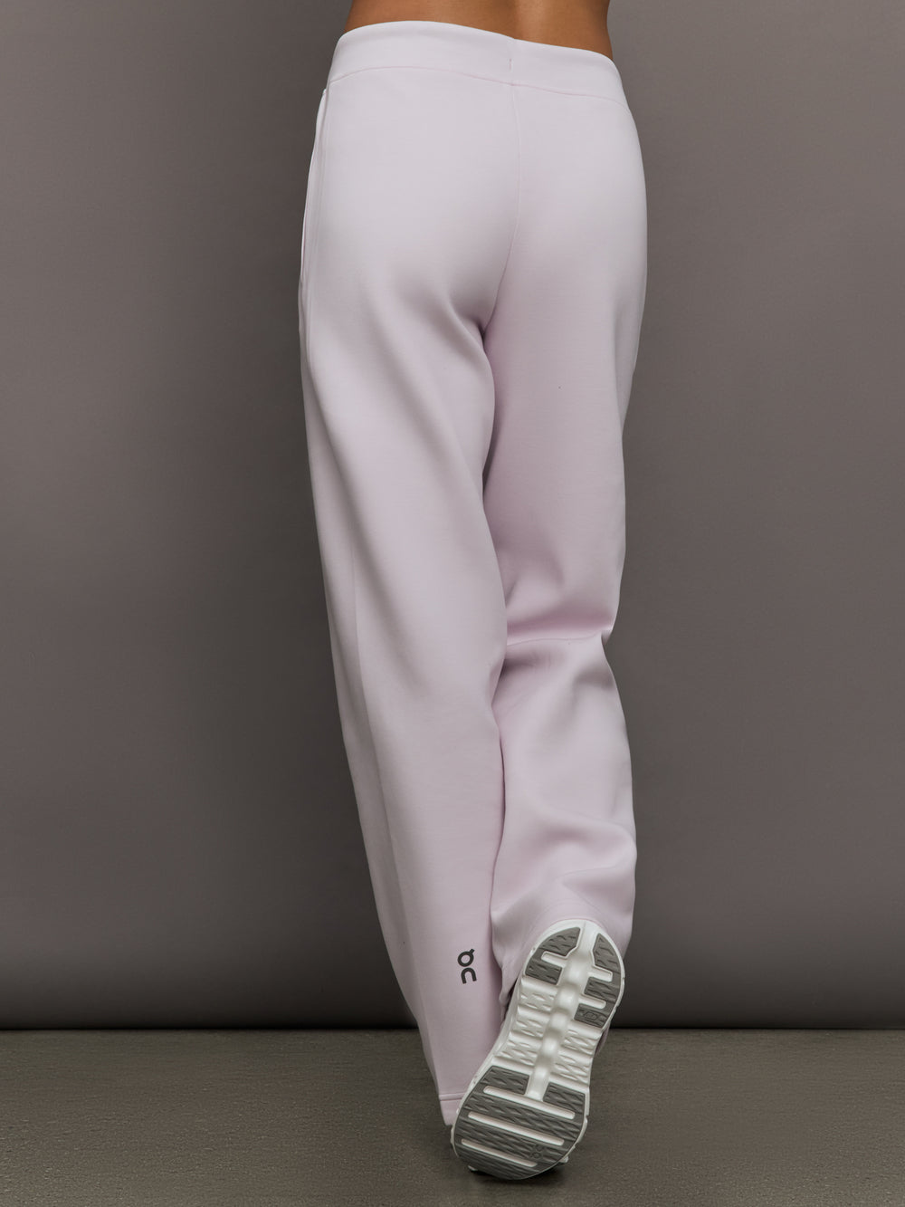 Model wears a pair of light purple sweatpants with black drawstring.