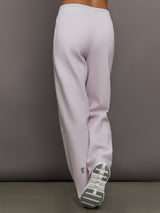 Model wears a pair of light purple sweatpants with black drawstring.