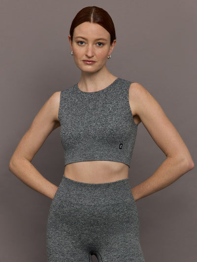 Model is wearing Studio Knit Seamless Crop in Graphite Heather, front view.