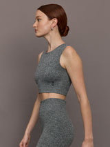 Model is wearing Studio Knit Seamless Crop in Graphite Heather, side profile view.
