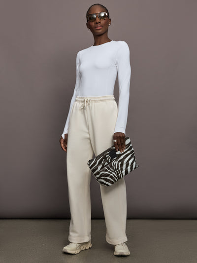 Model is wearing Club Collective wide-leg pants in Dew, full body front view.