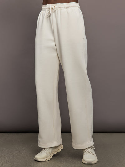 Model is wearing Club Collective wide-leg pants in Dew, front view.